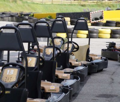Des kartings alignés sur un circuit, prêts à être pilotés